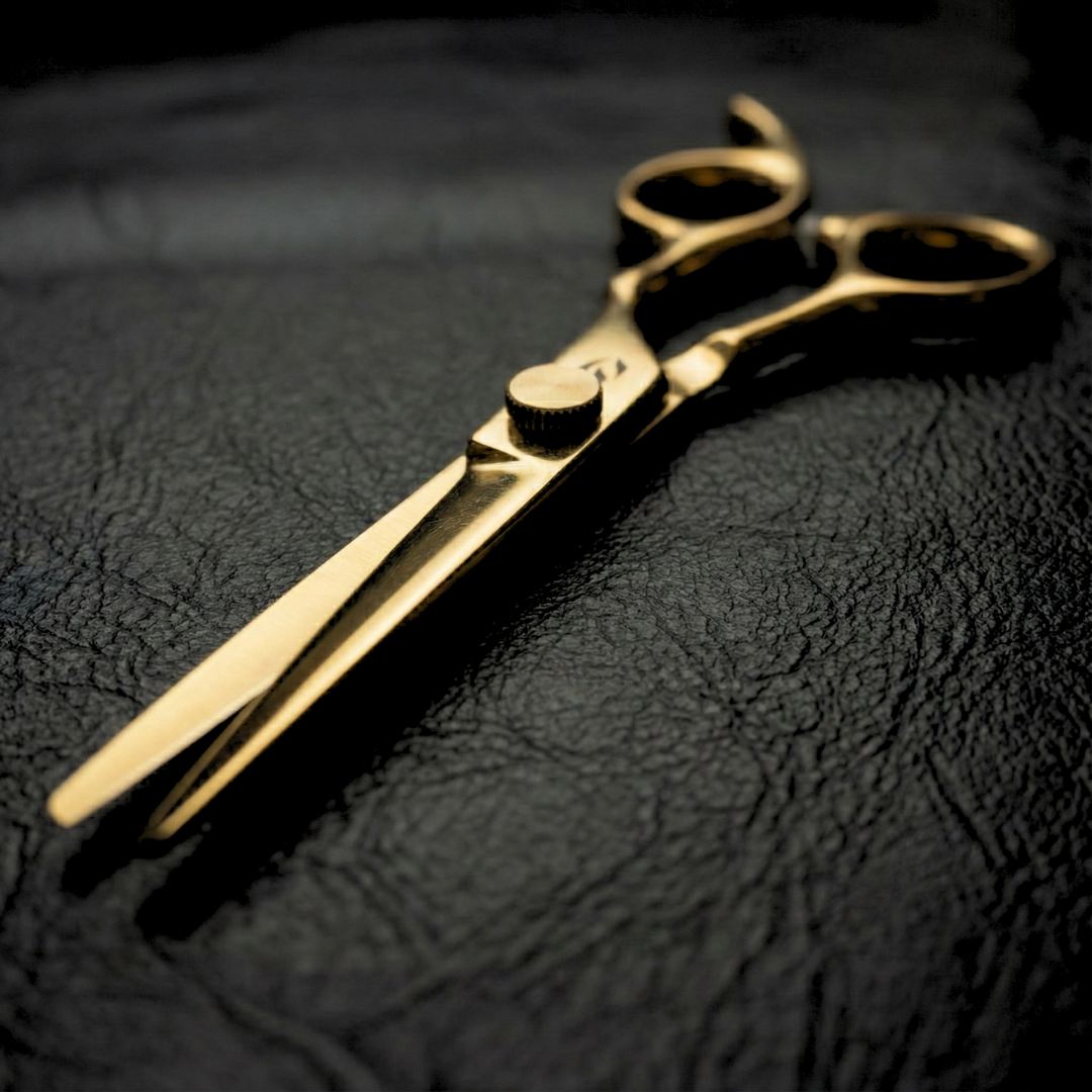 Satori gold barber shear profile view on black leather